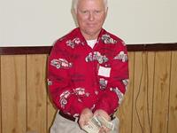 Ron shows the $250 a luvky winner will receive from the 50/50 drawing.
